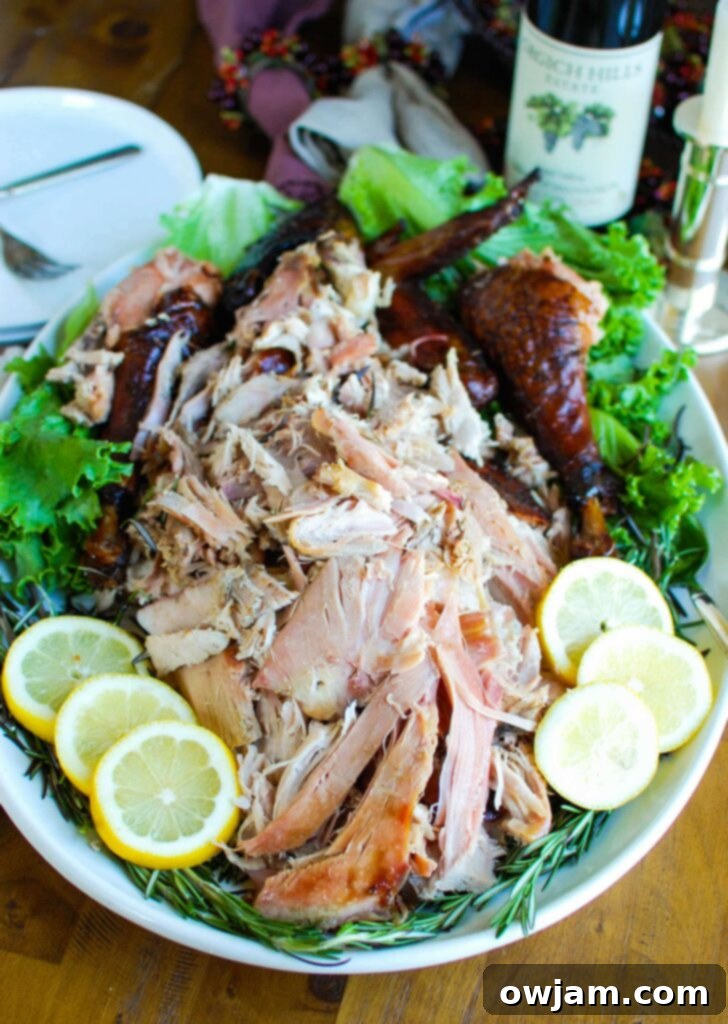 A beautifully golden-brown smoked turkey, sliced and garnished with fresh herbs and lemon, ready to be served at a holiday feast.