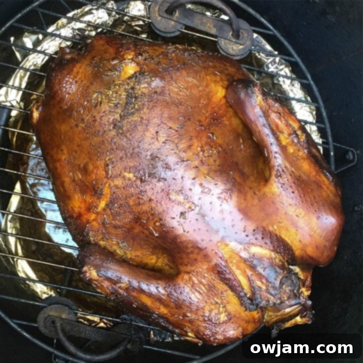 A rustic cutting board with slices of smoked turkey, garnished with lemon wedges and rosemary, ready for a holiday spread.