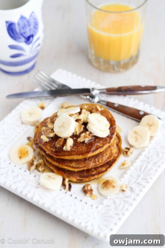 Whole Wheat Oat Gingerbread Pumpkin Pancakes served with syrup.
