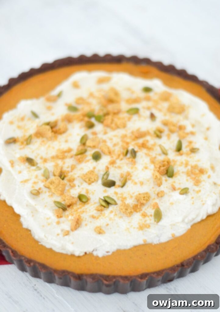 Elegant Pumpkin Chocolate Tart slice with chocolate ganache.