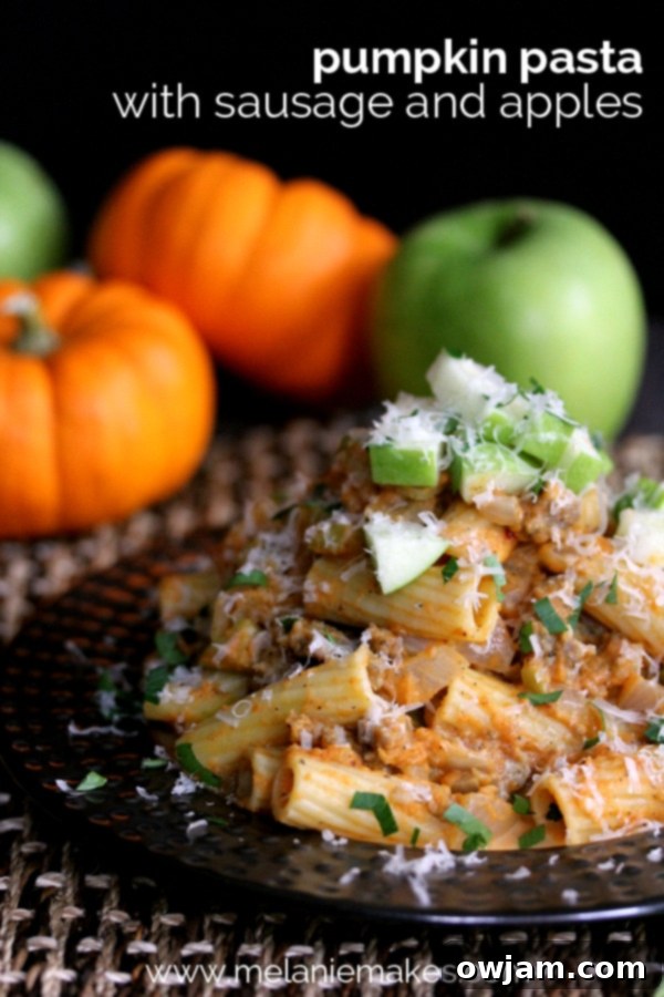 Pumpkin Pasta with Apples and Sausage in a rustic bowl.