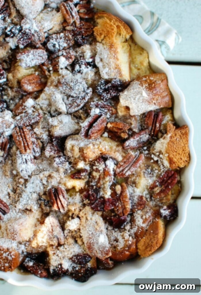 Close-up of the delicious Overnight Eggnog French Toast Bake, showcasing its moist texture and cranberry accents, perfect for a cozy holiday brunch.