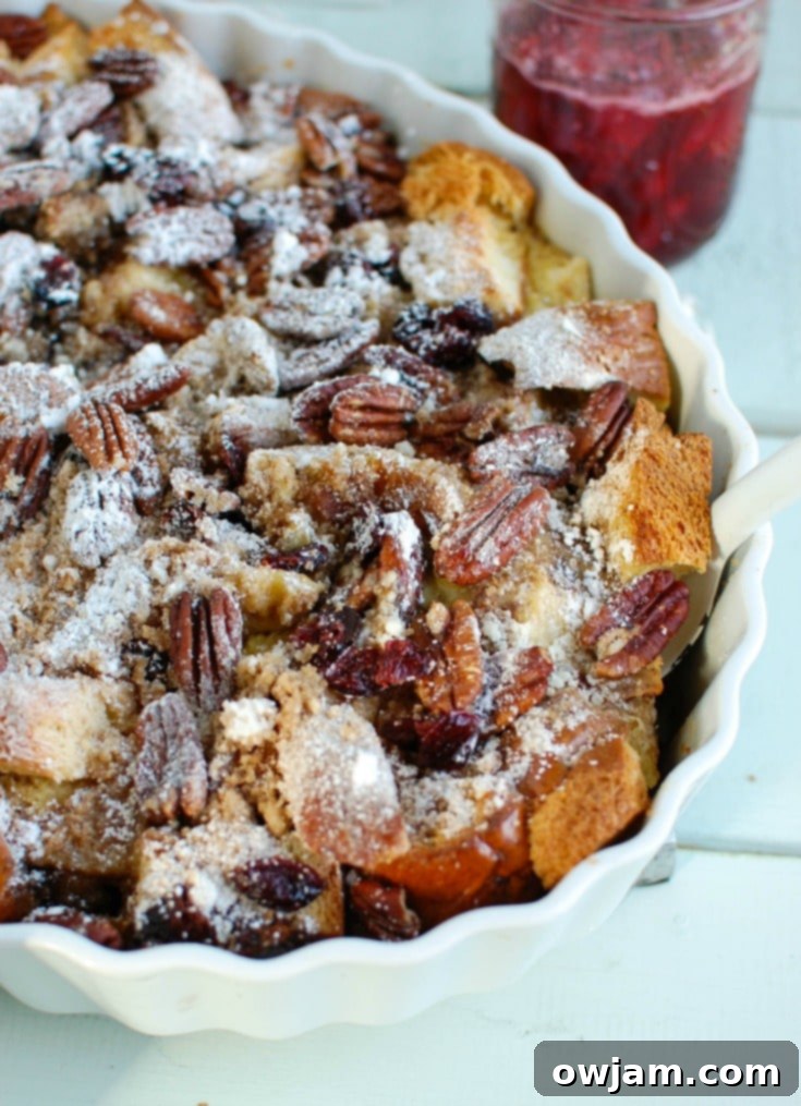 A charming close-up of the Overnight Eggnog French Toast Bake, showcasing its golden crust and the inviting texture of the bread, ready for a family feast.