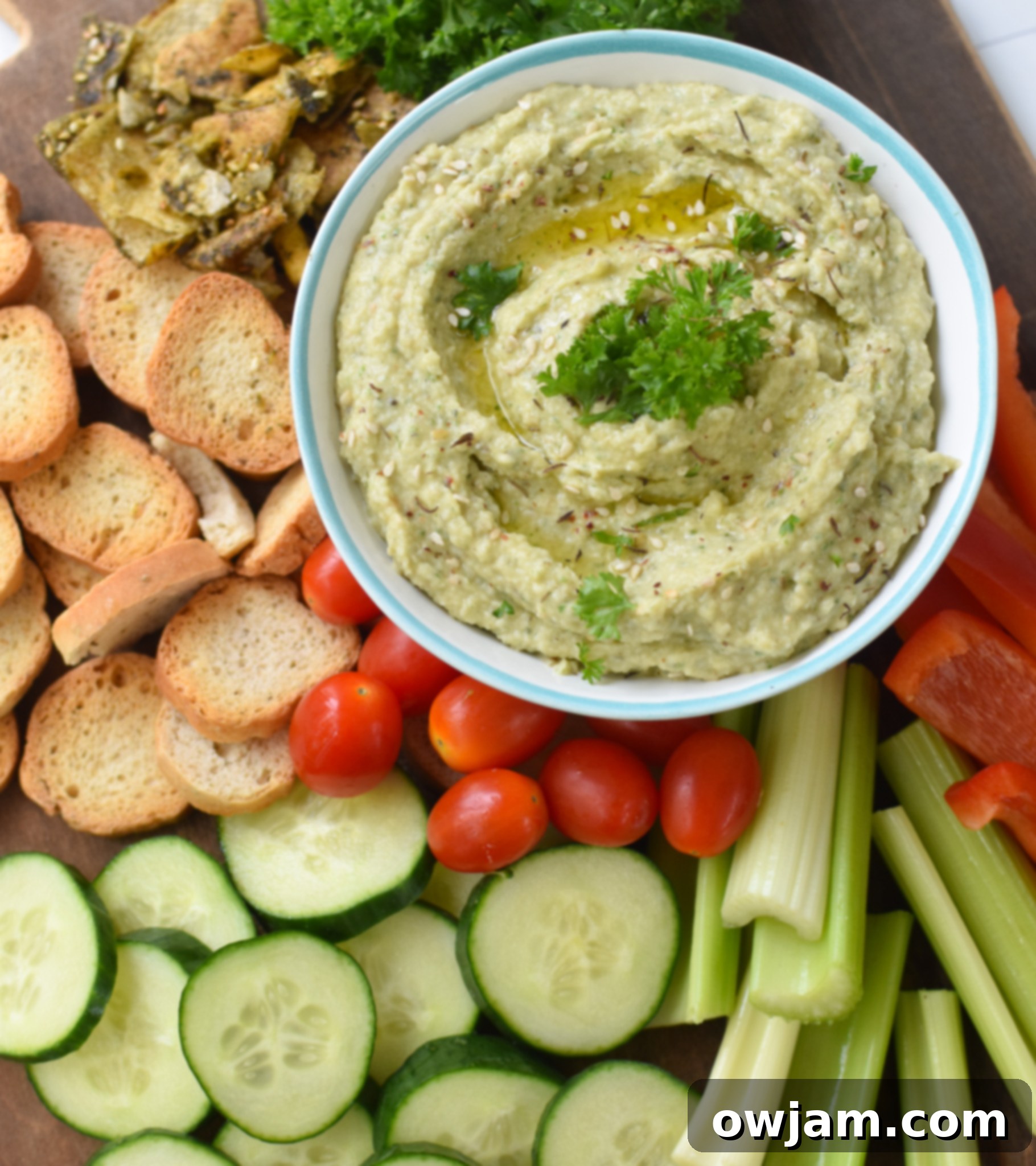 Creamy White Bean Artichoke Dip 2 White Bean Artichoke Dip with vegetables on a platter.