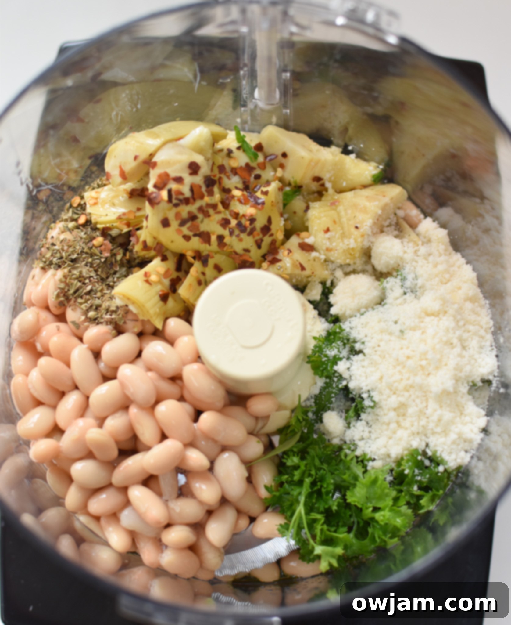 White Bean Artichoke Dip ingredients in a food processor before blending.