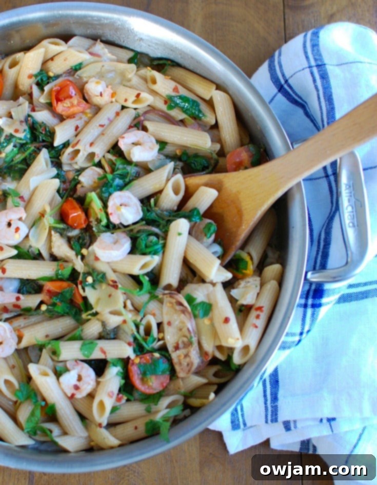 Zesty Shrimp Kale and Artichoke Pasta 3 Close-up of Shrimp Kale Artichoke Pasta in a rustic bowl, highlighting the perfectly cooked shrimp, wilted kale, and cherry tomatoes, all coated in a glossy lemon sauce.
