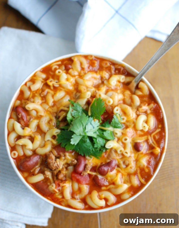 Close-up of Crock-Pot Turkey Chili Mac and Cheese, showing the rich texture of chili and melted cheese.