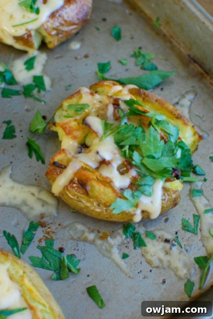 Golden potatoes are drizzled with olive oil and garlic and baked until crispy and then topped with gouda and warmed until the cheese is warm and melted. Gouda Smashed Potatoes are the perfect holiday side dish that will impress your guests.