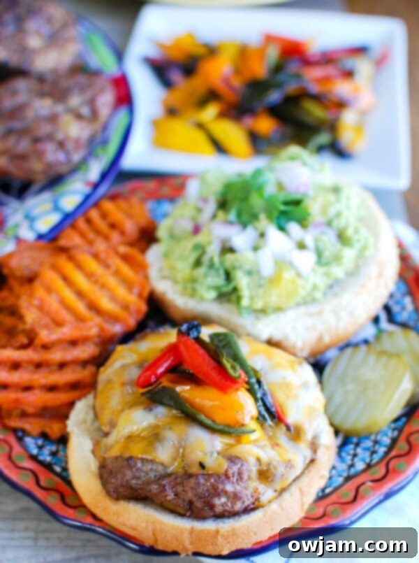 Southwestern Fiesta Burger with Sweet Guacamole 2 Close-up of a perfectly grilled Southwestern Hamburger topped with a generous dollop of sweet pineapple guacamole, nestled in a bun.