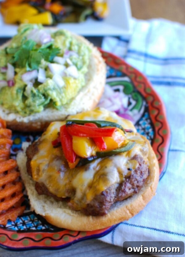 Southwestern Fiesta Burger with Sweet Guacamole 3 Two Southwestern hamburgers on buns with sweet guacamole and grilled peppers, ready to be served.