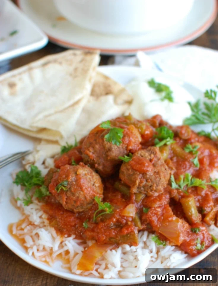 Savory Mediterranean Slow Cooker Beef Meatballs 3 Slow Cooker Mediterranean Beef Meatballs simmering in a rich tomato and green bean sauce in a crockpot.