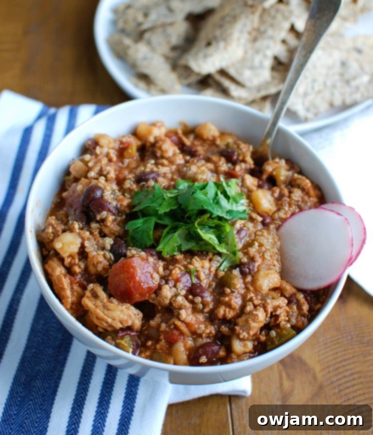 Slow Cooker Turkey Quinoa Chili is hearty, healthy and cooks all day in your crockpot! You can come home to a warm, comforting bowl of chili without spending time in the kitchen. This is perfect for dinner or watching football!