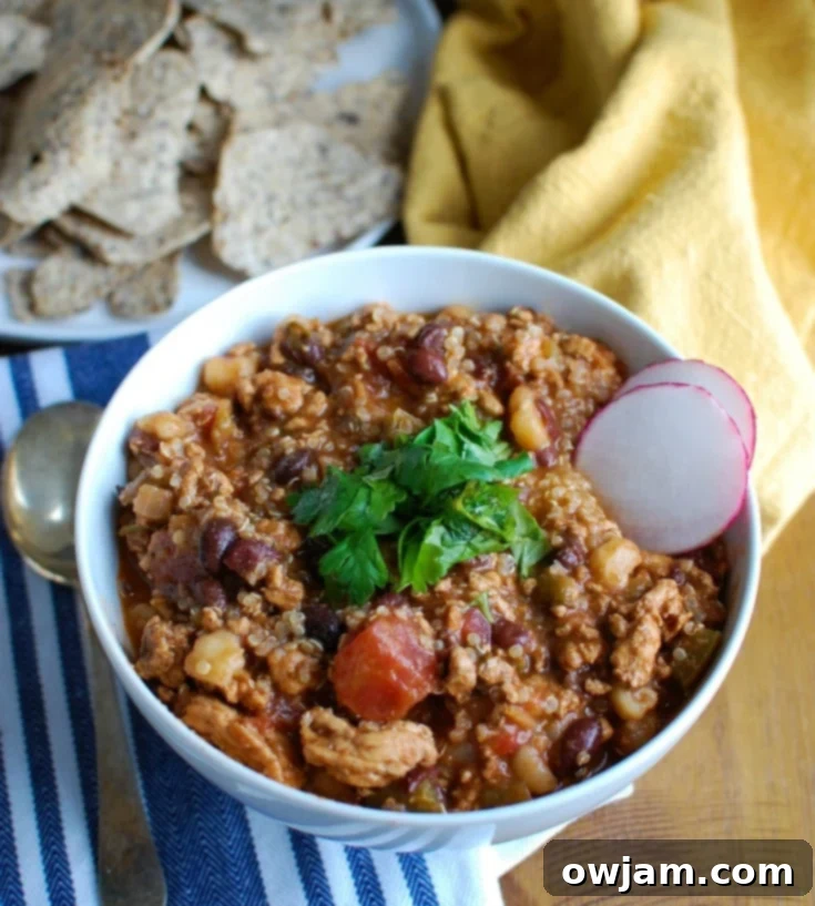 Slow Cooker Turkey Quinoa Chili is hearty, healthy and cooks all day in your crockpot! You can come home to a warm, comforting bowl of chili without spending time in the kitchen. This is perfect for dinner or watching football