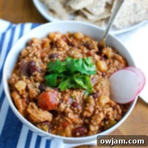 Slow Cooker Turkey Quinoa Chili is hearty, healthy and cooks all day in your crockpot! You can come home to a warm, comforting bowl of chili without spending time in the kitchen. This is perfect for dinner or watching football