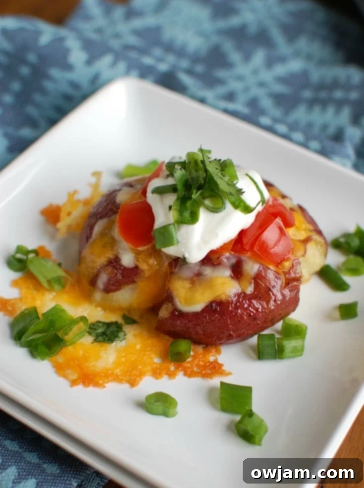 Crispy Loaded Smashed Spuds 3 Loaded Smashed Potatoes are crispy on the outside and soft on the inside and loaded with cheese, sour cream, tomatoes, green onion and cilantro. These make an easy family meal or appetizer for game day or a party!