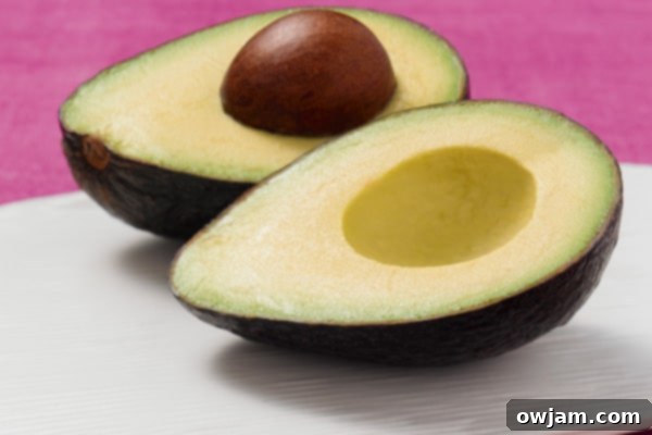 Zesty Mexican Tuna Avocado Boats 4 Pink avocado background illustrating the freshness and health benefits of avocados