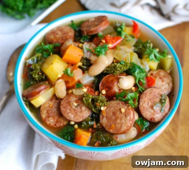 Tuscan Slow Cooker Sausage Kale White Bean Soup 4 Ingredients for Slow Cooker Sausage Kale White Bean Soup laid out on a cutting board, including fresh kale, carrots, celery, onion, and spices.