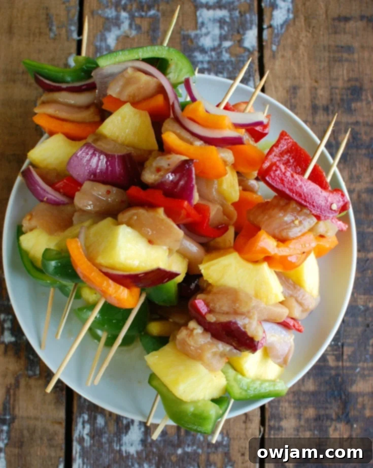 Paradise Chicken Skewers 2 Hawaiian Chicken Kabobs on a white plate