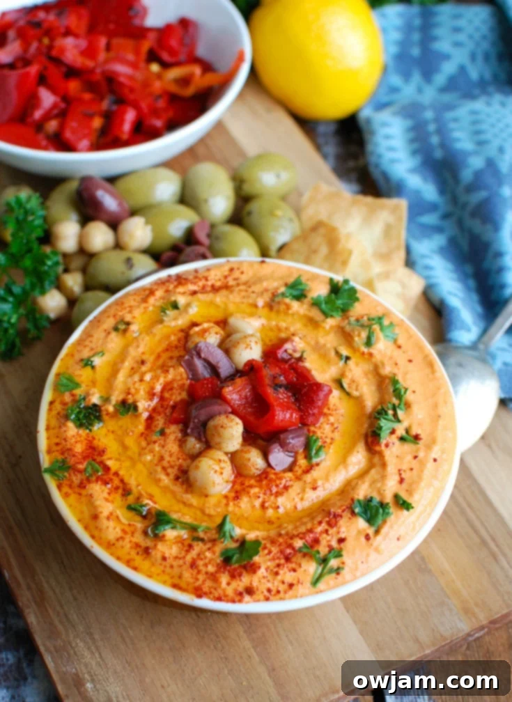 Creamy Roasted Red Pepper and Greek Yogurt Hummus 4 Step-by-step image of ingredients being added to a food processor for Roasted Red Pepper Greek Yogurt Hummus.