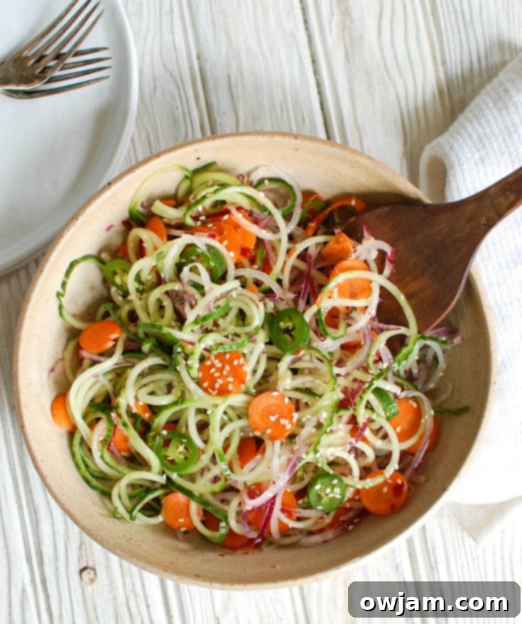 Zesty Asian Cucumber Noodle Salad 4 Asian Cucumber Noodle Salad is a light and healthy salad or side dish. Cucumber and red onion noodles, carrots and jalapeños are tossed with a light Asian dressing.