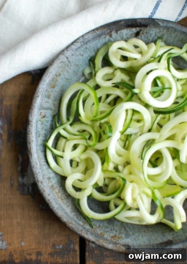 Close-up of Spicy Chicken Zoodle Soup with abundant zucchini noodles