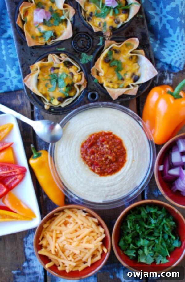 Fiesta Hummus Wonton Bites 5 Platter of freshly baked Southwestern Hummus Wonton Cups garnished with fresh cilantro and red onion, ready to be served.
