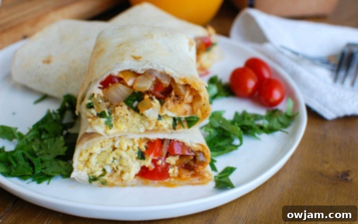 Vegetarian Breakfast Egg Burritos arranged on a serving plate, showing the vibrant filling.