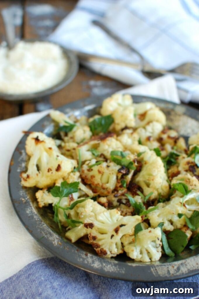 Crispy Parmesan Garlic Cauliflower 3 Close-up of golden brown Roasted Parmesan Garlic Cauliflower florets, fresh out of the oven, with melted cheese and ready to serve. A perfect healthy side dish.