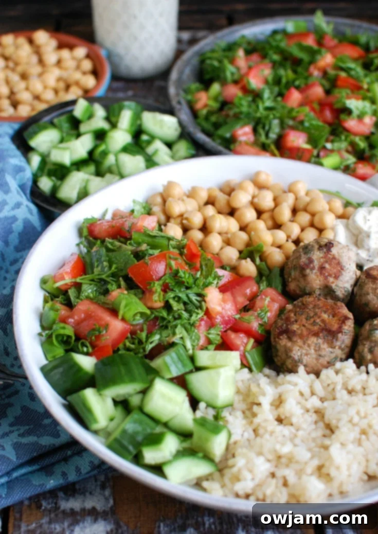Mediterranean Baked Turkey Meatballs served in a bowl with a spoon, highlighting their texture.