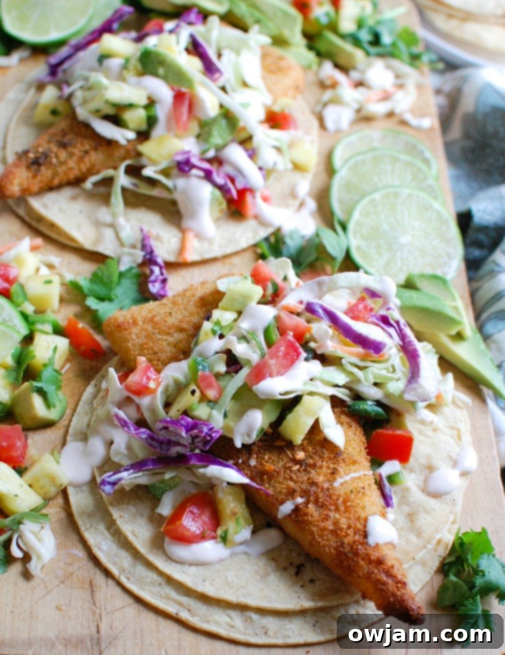 Easy Fish Tacos with Spicy Pineapple Salsa is a quick and easy meal that doesn't lack flavor! These are the perfect way to mix up taco night with baked breaded cod tacos topped with a spicy pineapple salsa and a spicy slaw.