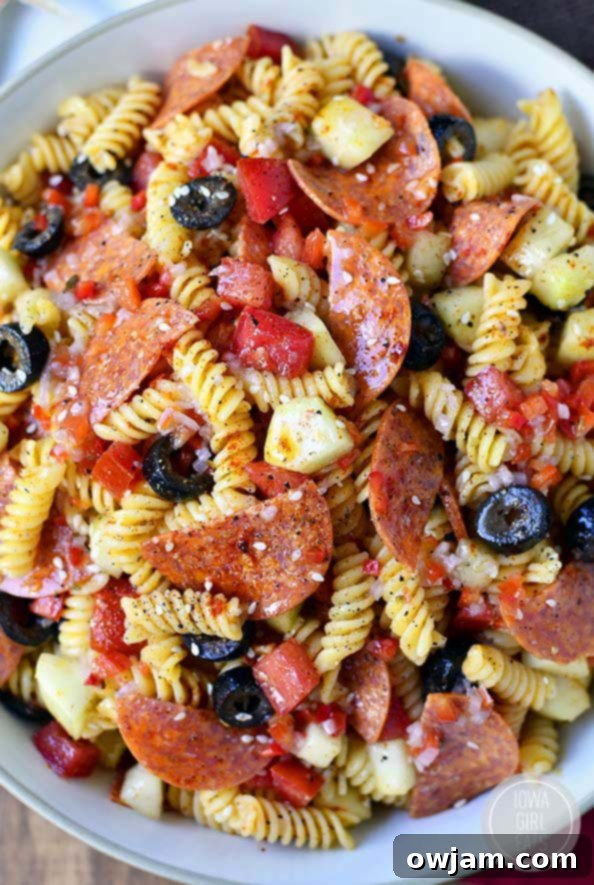 The Best Pasta Salad, loaded with colorful vegetables and a creamy dressing.
