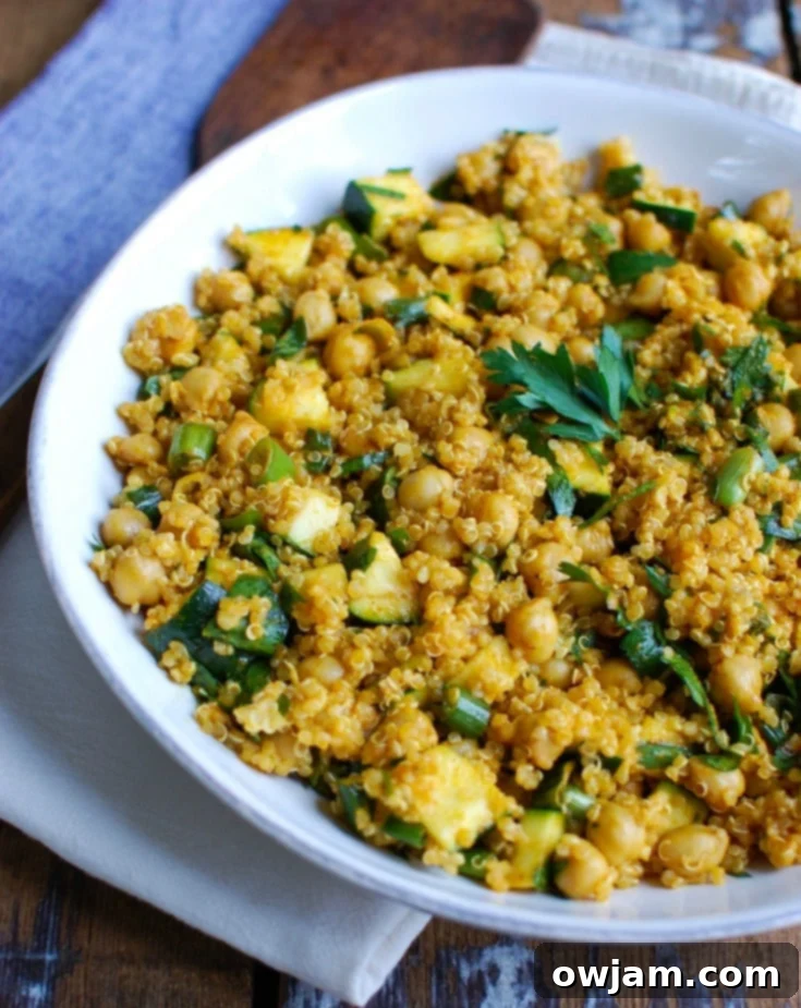 Zucchini Chickpea Quinoa Salad mixes zucchini, chickpeas, quinoa, fresh parsley and green onions and is tossed in a spiced olive oil dressing. This salad has the rich, warm flavors of cumin, turmeric and paprika and makes a healthy, filling lunch.