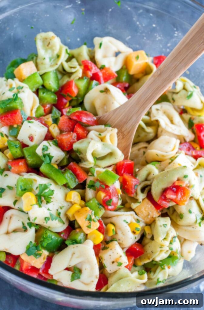 Make-ahead party perfect garden veggie tortellini pasta salad with fresh vegetables.