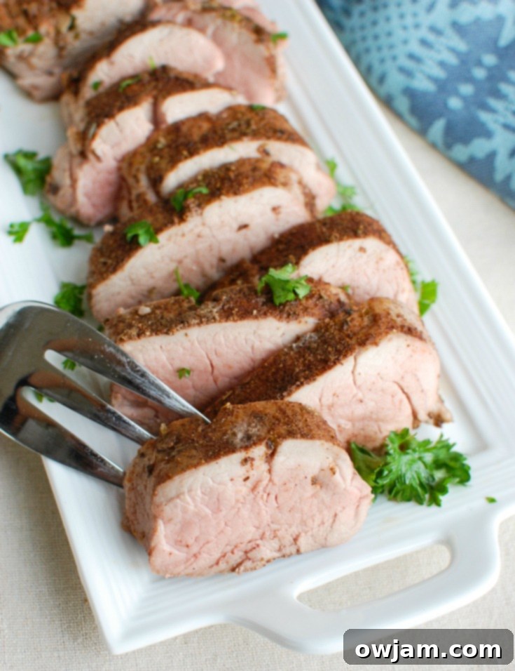 Mediterranean Pork Tenderloin Bake 6 Mediterranean Baked Pork Tenderloin with a fork.