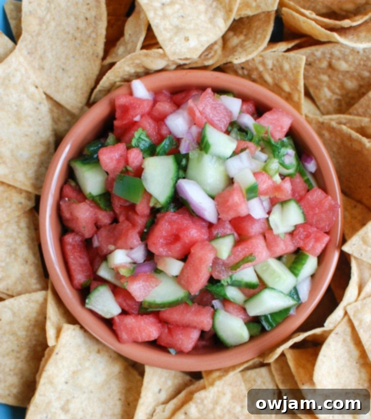 Refreshing Cucumber Salsa 4 Watermelon Cucumber Salsa served in a white bowl with tortilla chips, ready for a refreshing snack or party appetizer.
