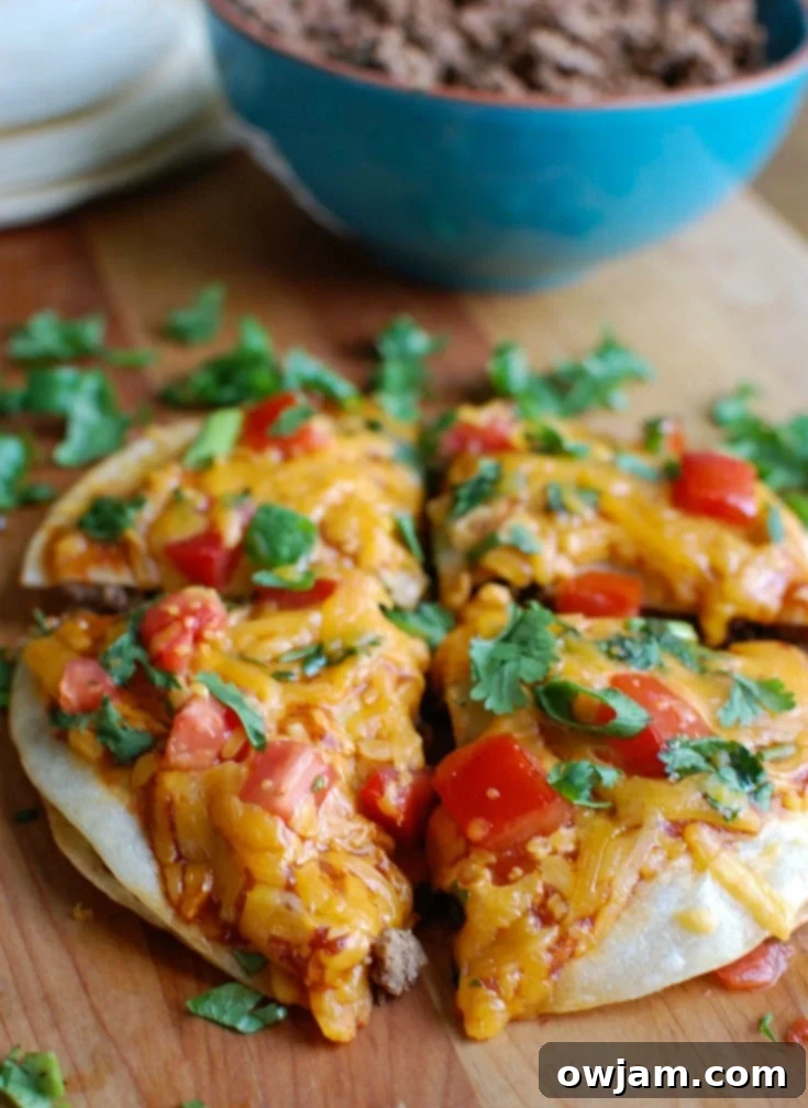 Cheesy Chicken and Broccoli Bake 11 Easy Mexican Pizza, layered with refried beans, seasoned ground beef, salsa, and melted Sargento® Shredded Monterey Jack Cheese, garnished with fresh cilantro and tomatoes.
