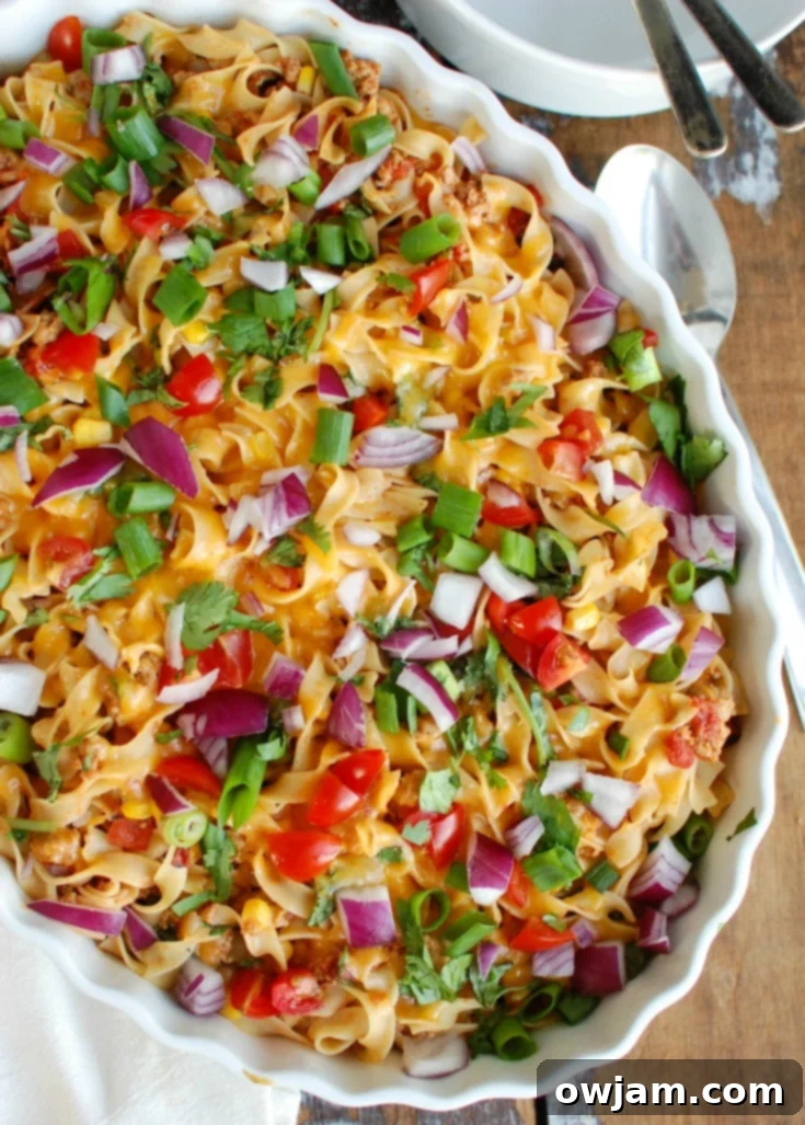 Ingredients for Easy Mexican Noodle Casserole laid out on a kitchen counter: No Yolks Noodles, ground turkey, fresh vegetables, taco seasoning, salsa, and cheese, ready for preparation.