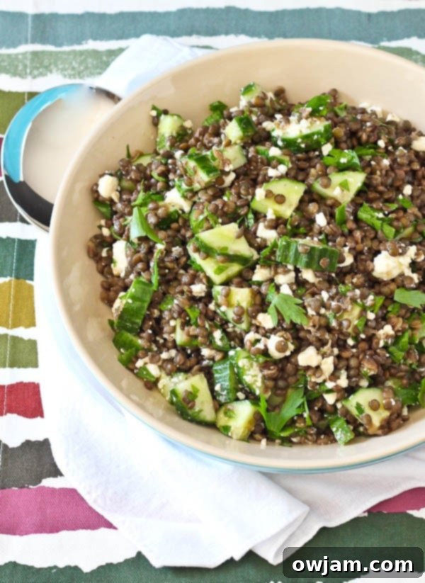 Fresh lentil salad with crumbled feta, lemon wedges, and chopped parsley.