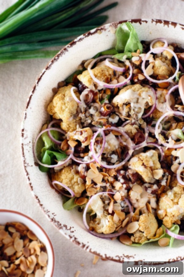 Roasted cauliflower salad with lentils, sweet dates, and a creamy tahini dressing.
