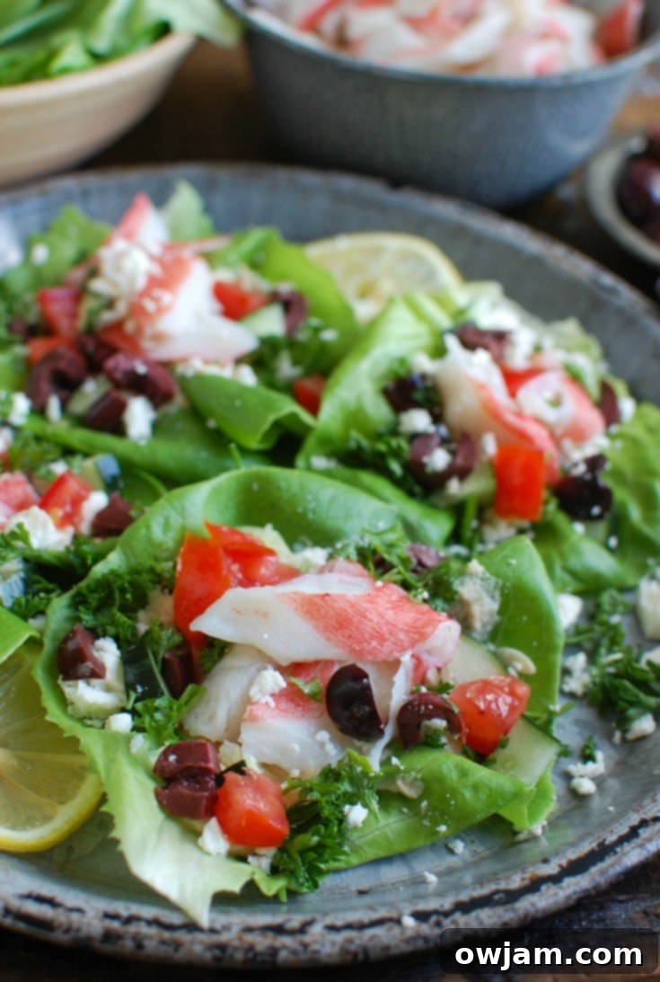 A vibrant platter of Mediterranean Surimi Lettuce Wraps ingredients, including fresh vegetables, feta, olives, and surimi, ready for assembly.