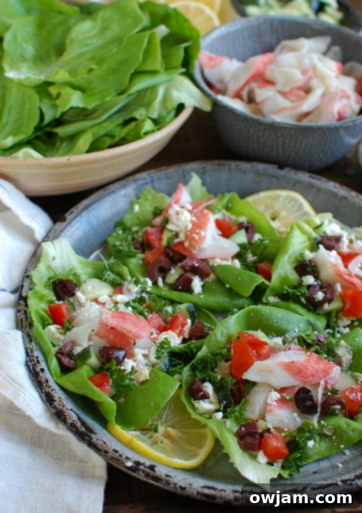 A beautifully presented stack of Mediterranean Surimi Lettuce Wraps with fresh garnishes.