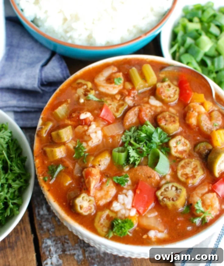 Crock-Pot Jambalaya Soup is rich with flavor and spice and packed with delicious New Orleans flavors. Chicken, andouille sausage and shrimp are simmered in a cajun spiced tomato broth and served with rice. This is comforting and a great meal to share with others!