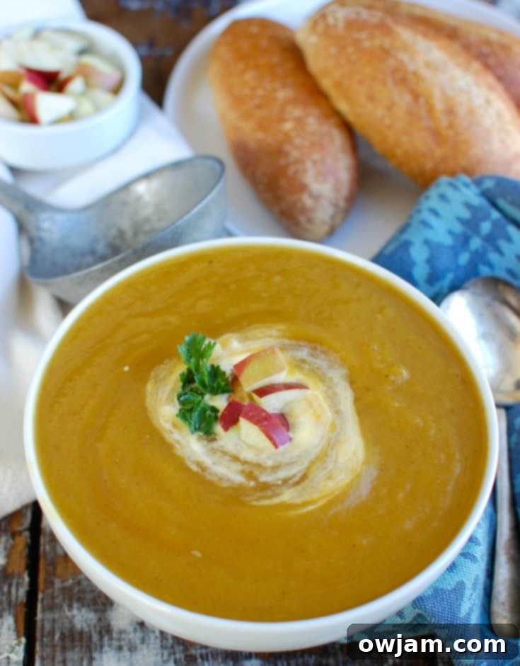 Butternut Apple Bliss Slow Cooker Soup 4 Creamy Slow Cooker Butternut Squash Apple Soup, garnished with parsley and a swirl of cream.