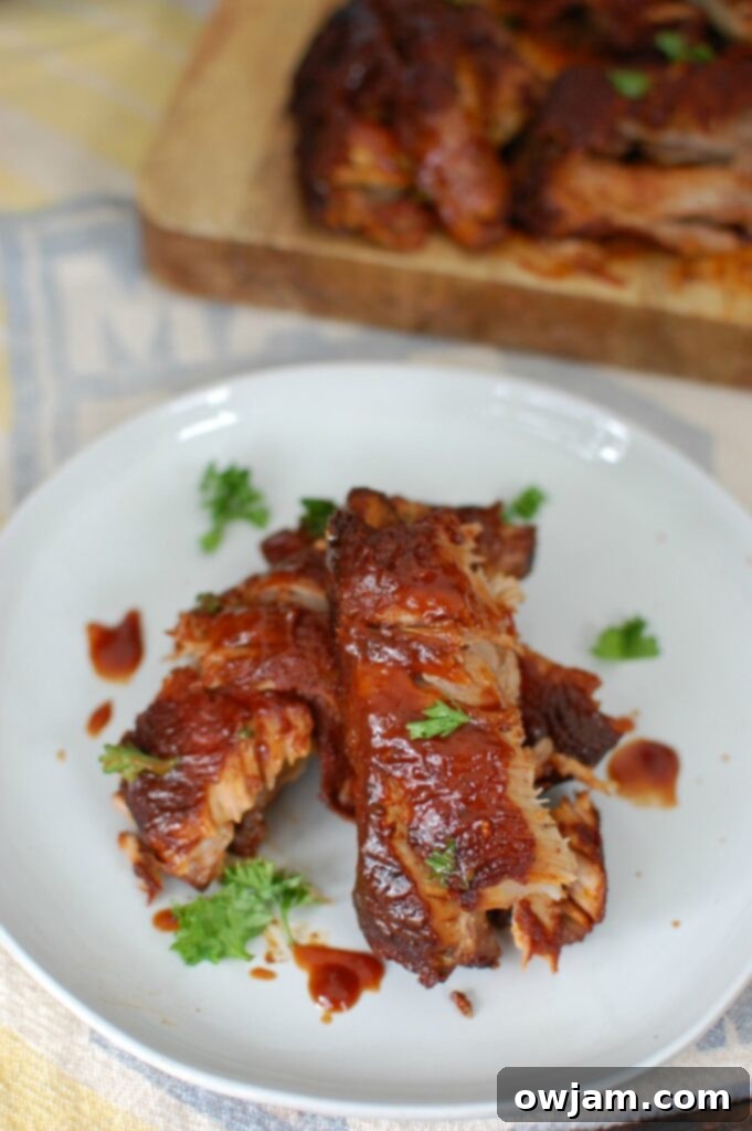Slow Cooker Ribs 2 Slow Cooker Barbecue Ribs are fall off the bone tender and full of warm spices and flavor. These ribs cook in a slow cooker saving you time and making this meal easy and perfect for a crowd!