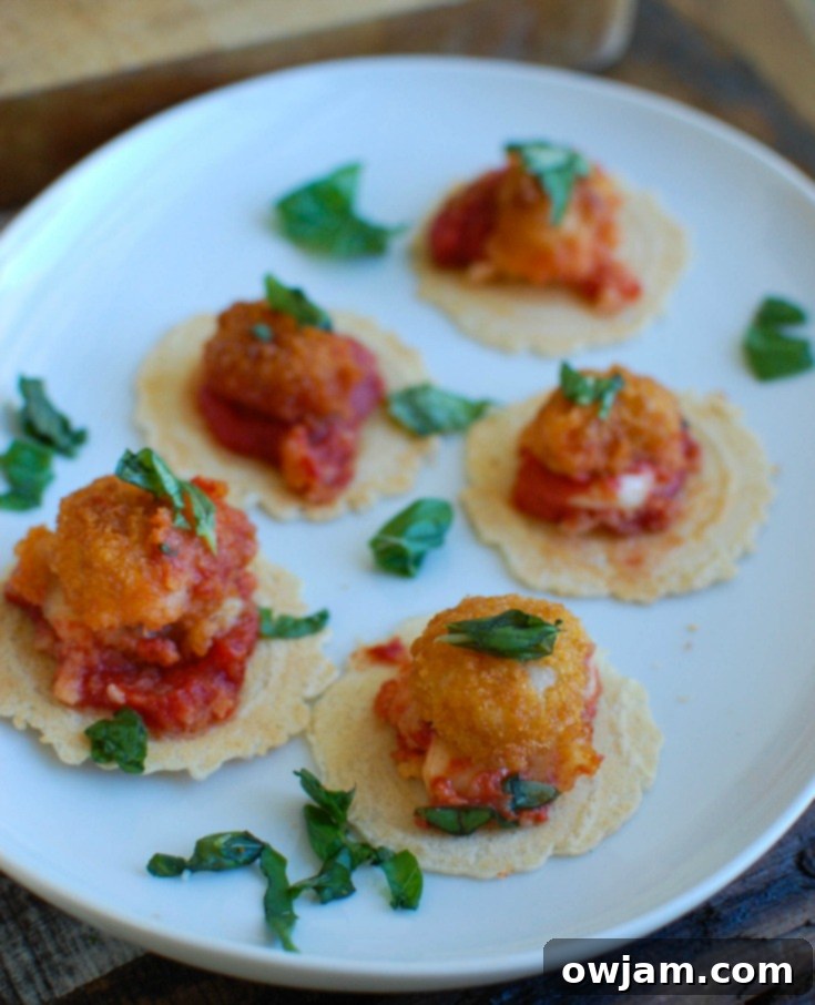 An overhead shot of Tomato Basil Mozzarella Popcorn Shrimp Bites in a festive skillet, ready to be served.