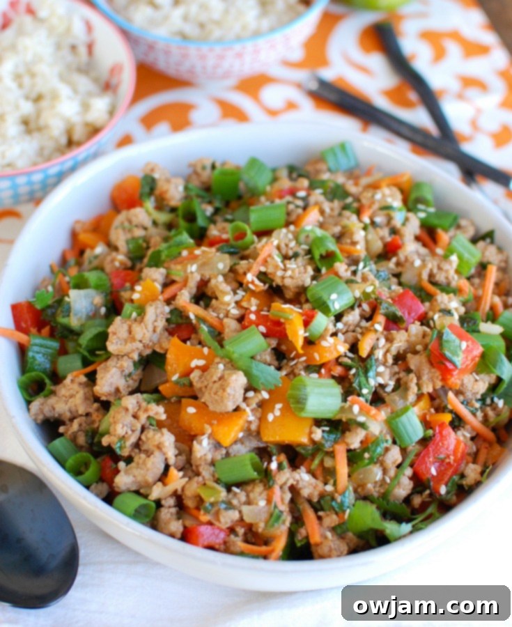 Effortless Thai Pork Stir-Fry 4 Close-up of Easy Thai Pork Stir-Fry in a pan, showing ground pork, bell peppers, carrots, and bok choy cooking