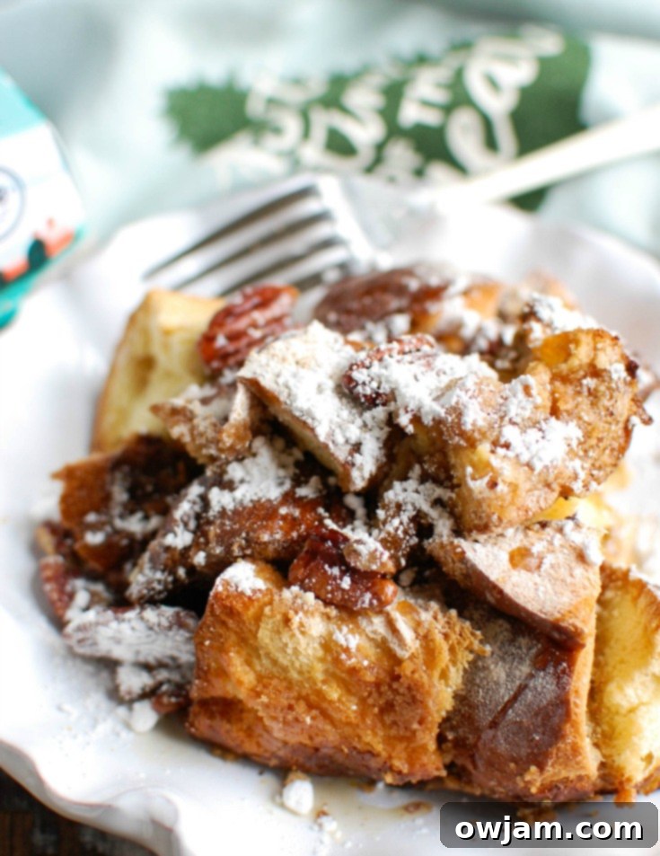 Festive Overnight Gingerbread French Toast Casserole 7 The baked Gingerbread French Toast Casserole in the baking dish, garnished and ready for a holiday brunch.