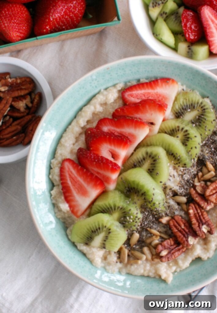 Fresh Strawberry Kiwi Chia Oat Breakfast 2 A beautifully arranged Strawberry Kiwi Chia Seed Oat Bran Bowl, topped with fresh strawberries, kiwi slices, chia seeds, pecans, and sunflower seeds, ready to be enjoyed for a healthy breakfast.