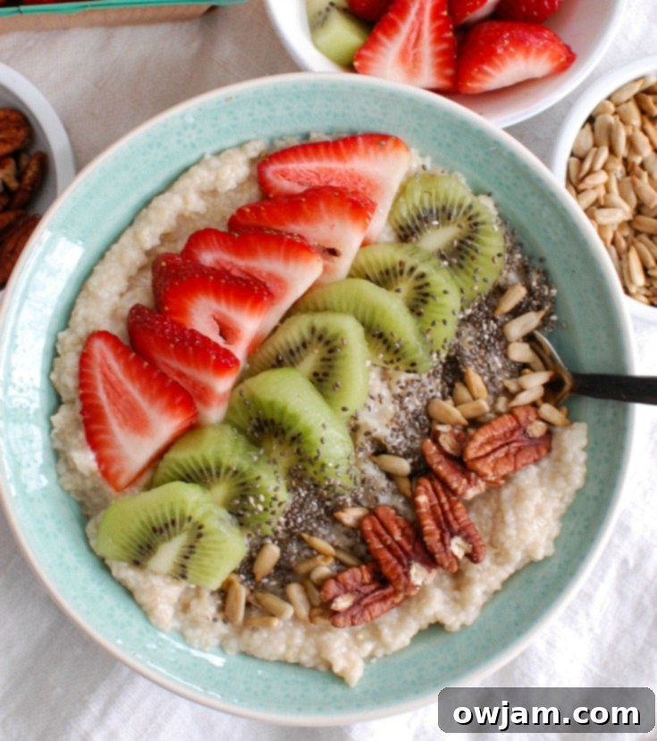 Fresh Strawberry Kiwi Chia Oat Breakfast 4 Overhead shot of a vibrant Strawberry Kiwi Chia Seed Oat Bran Bowl, with a spoon nestled in, inviting the viewer to enjoy this healthy and visually appealing breakfast.