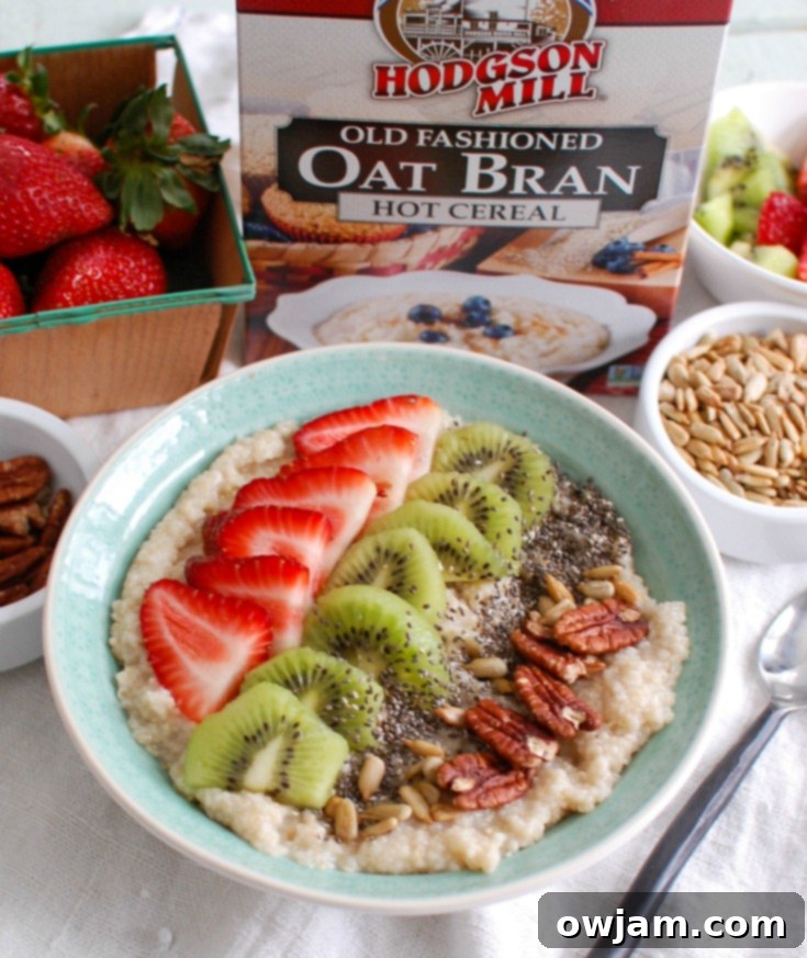 Fresh Strawberry Kiwi Chia Oat Breakfast 5 A close-up of the Strawberry Kiwi Chia Seed Oat Bran Bowl with hands reaching for it, emphasizing its appeal and readiness to be enjoyed.